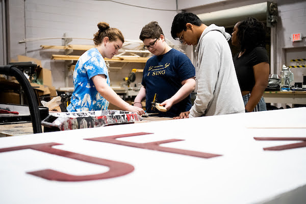 Students working at the light and sound board