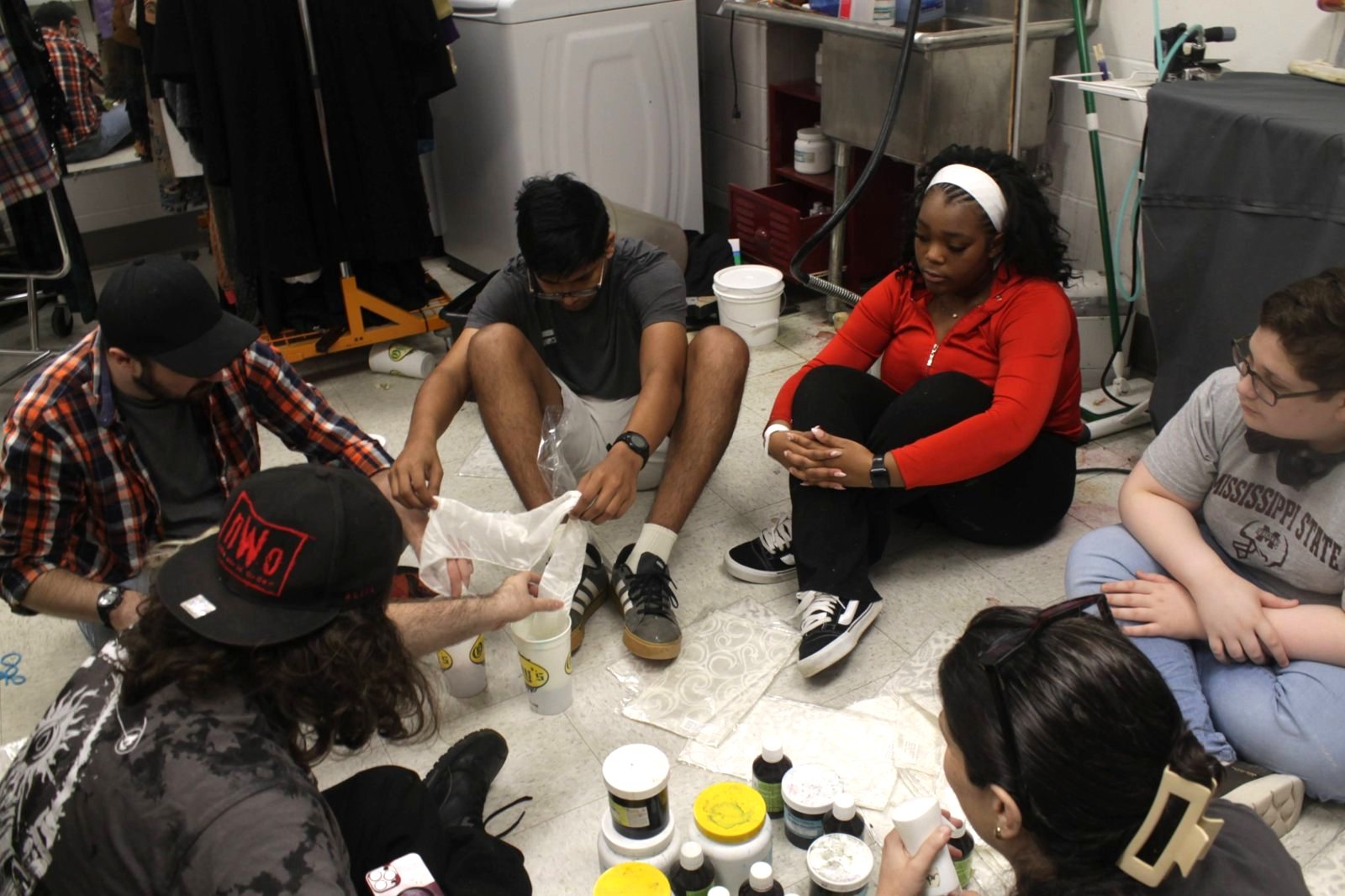 Students working with lights, sound, and set pieces in the theatre